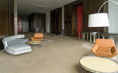 modern-hotel-lobby-with-leather-sofa-chairs-lamp-round-tables-min